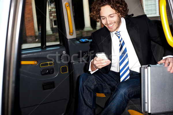 Man messaging through cellphone inside taxi cab Stock photo © stockyimages