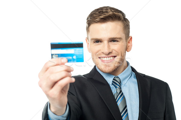 Businessman displaying his cash card Stock photo © stockyimages