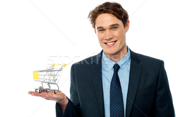 Businessman presenting shopping cart Stock photo © stockyimages