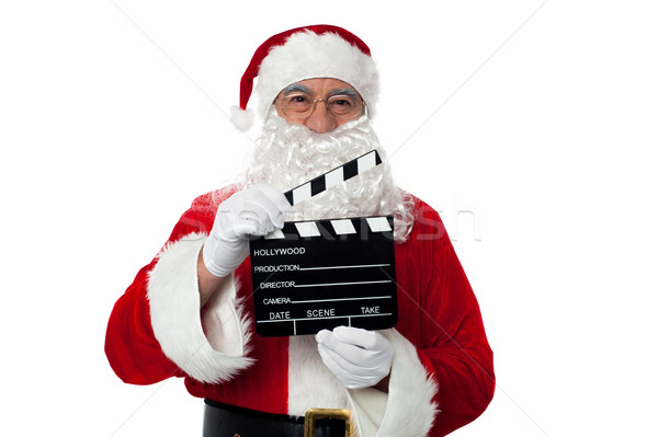 Cheerful aged Santa posing with a clapperboard Stock photo © stockyimages