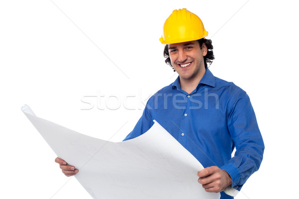 Stock photo: Construction worker reviewing blueprint