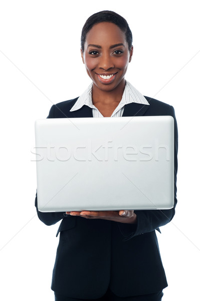 Corporate lady holding brand new laptop Stock photo © stockyimages