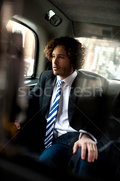 Handsome business executive inside taxi cab Stock photo © stockyimages