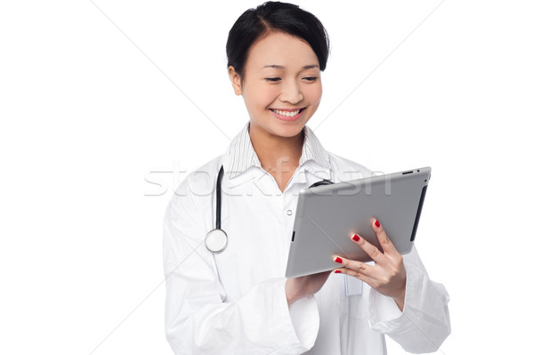 Stock photo: Young female doctor holding a tablet