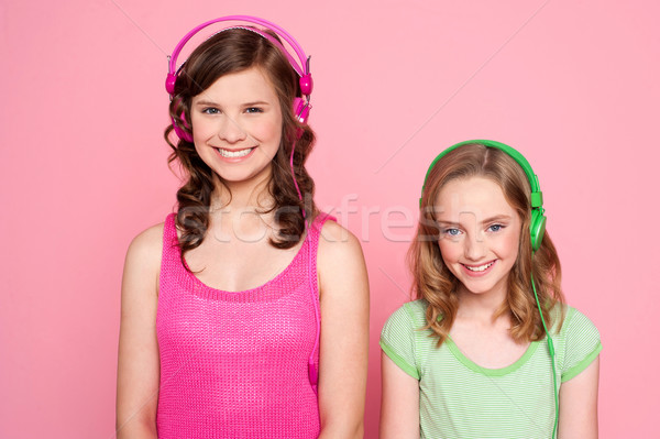 Smiling girls posing with headphone Stock photo © stockyimages