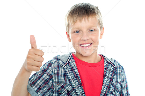 Boy in trendy clothes showing thumbs up sign Stock photo © stockyimages