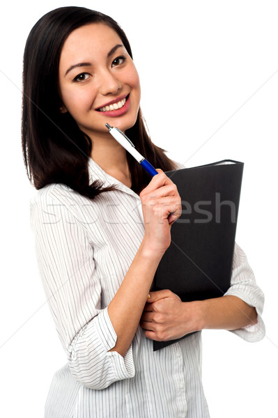 Female executive holding business file and pen Stock photo © stockyimages