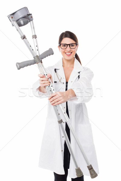 Female doctor handing over crutches Stock photo © stockyimages