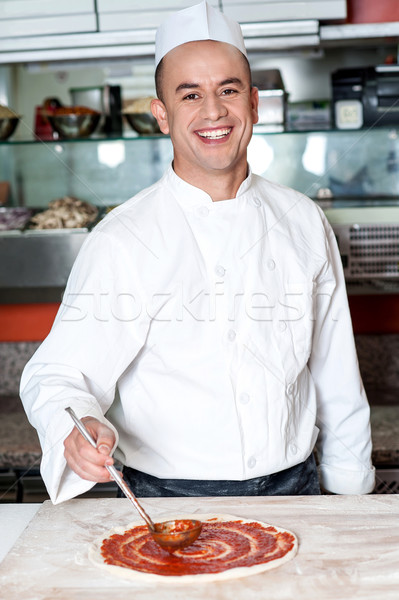 Smiling chef making pizza Stock photo © stockyimages
