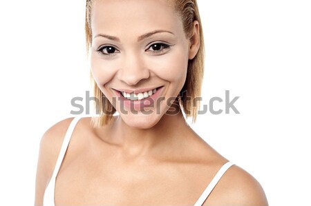 Pretty young woman smiling warmly Stock photo © stockyimages
