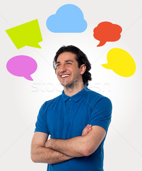 Confident young man with speech bubbles Stock photo © stockyimages