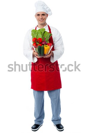 Chef holding glass bowl full of vegetables Stock photo © stockyimages