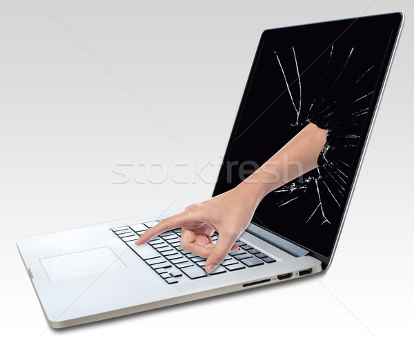 Laptop with broken screen and hand Stock photo © stockyimages