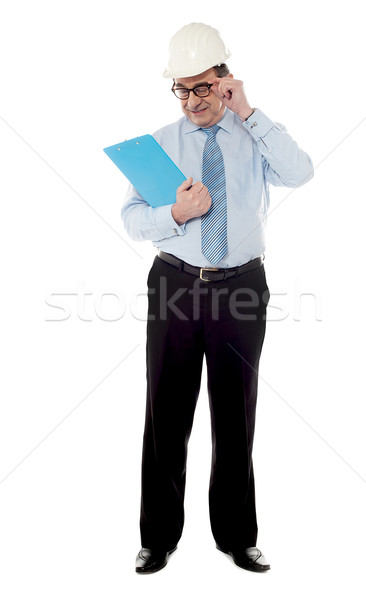 Elder architect studying file Stock photo © stockyimages