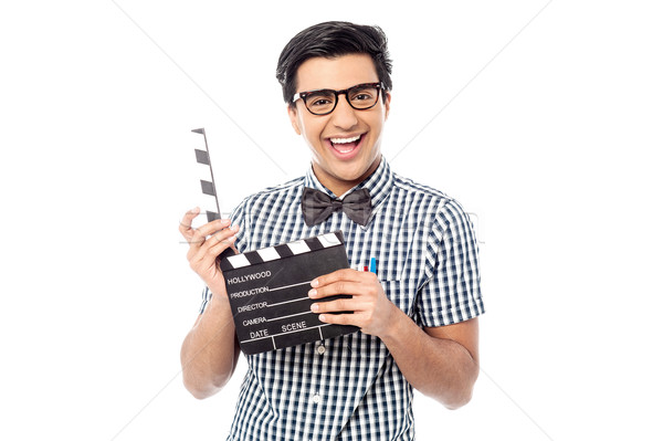 Smiling man holding a movie clap Stock photo © stockyimages