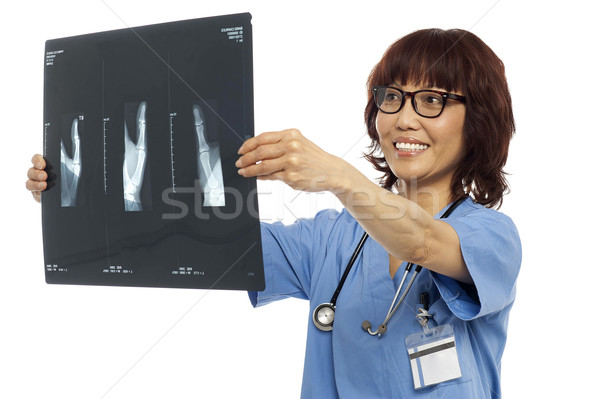 Female doctor reviewing x-ray report Stock photo © stockyimages