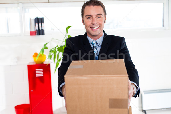 Active executive carrying packed carton Stock photo © stockyimages