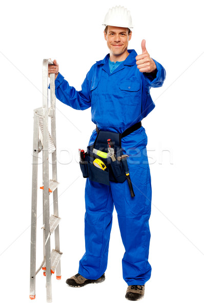 Repairman holding ladder and showing thumbs up Stock photo © stockyimages