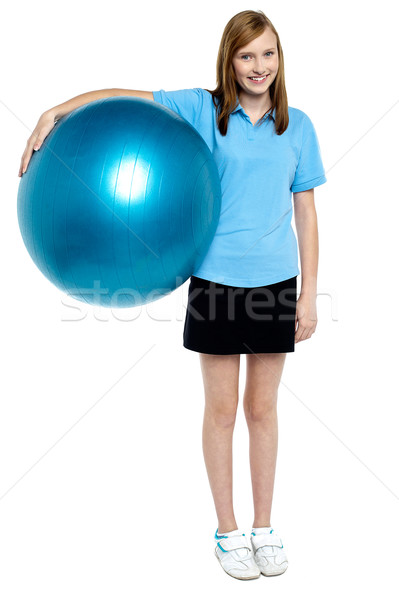 Slim and fit teen girl holding a swiss ball Stock photo © stockyimages