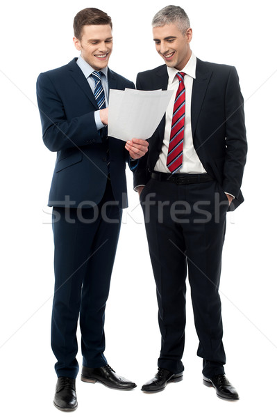 Businessmen evaluating deal documents Stock photo © stockyimages