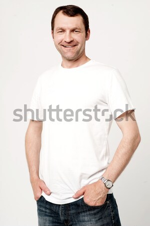 Happy young man posing casually  Stock photo © stockyimages