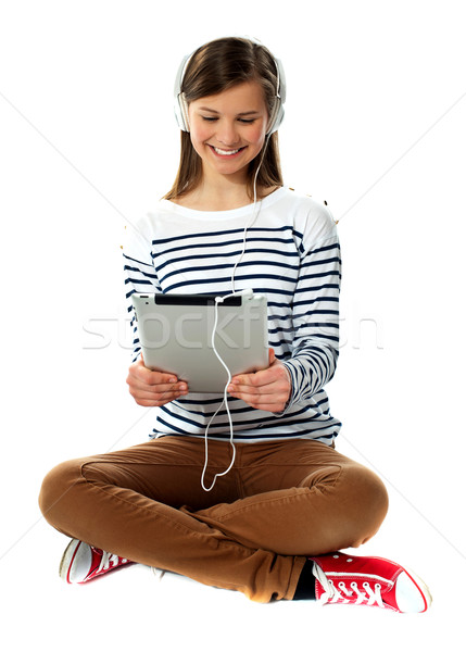 Girl watching video on her tablet Stock photo © stockyimages