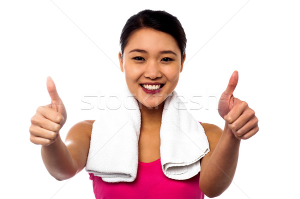Stock photo: Attractive woman showing double thumbs up