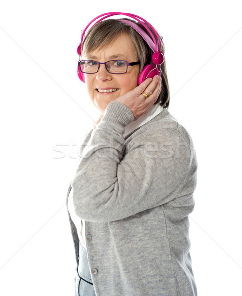 Aged woman enjoying music Stock photo © stockyimages