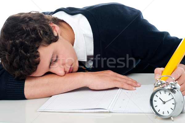 Teenager dozing off while writing his test Stock photo © stockyimages