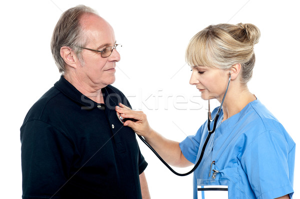 Stock photo: Female doctor examining an elderly man