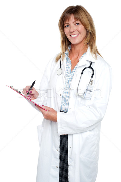 Pleasing doctor collecting patient's health history Stock photo © stockyimages