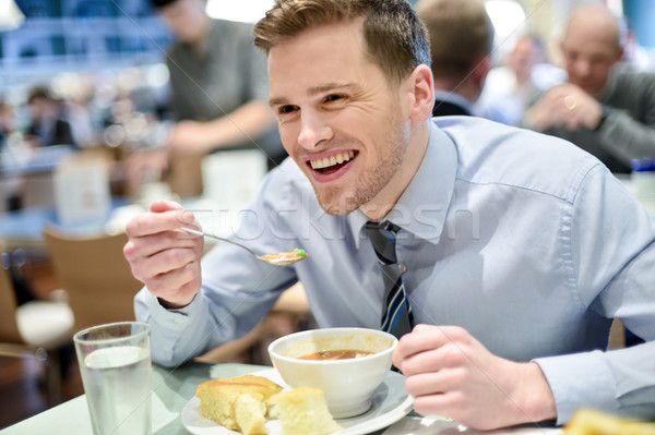 Smiling young businessman having lunch Stock photo © stockyimages