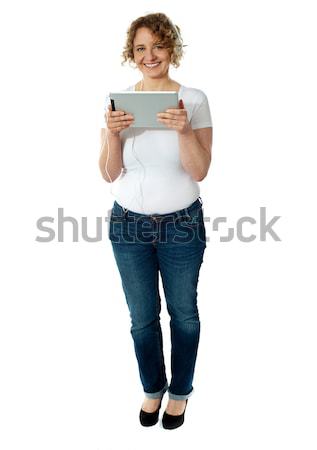 Charming lady tuned into musical world Stock photo © stockyimages
