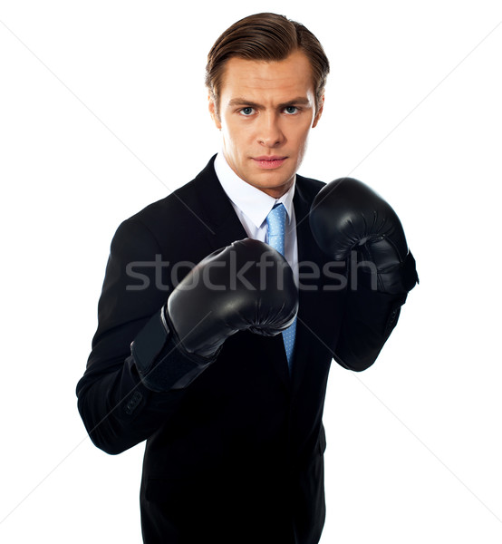 Handsome businessman posing in boxing gloves Stock photo © stockyimages