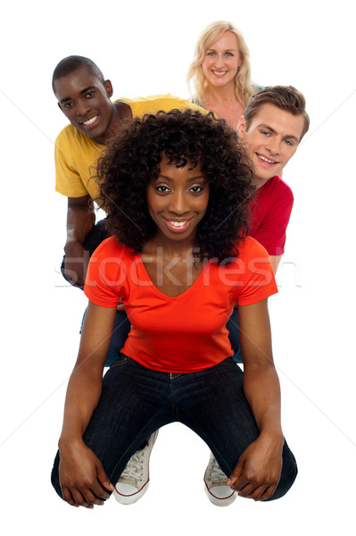 Line of teens with behind ones peeping out Stock photo © stockyimages