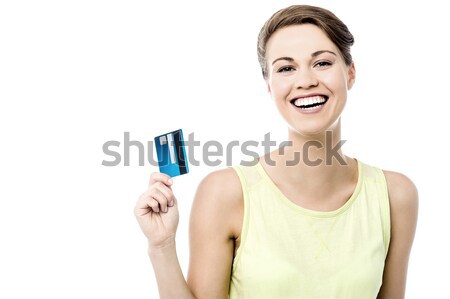 Girl showing her cash card, arm stretched out Stock photo © stockyimages