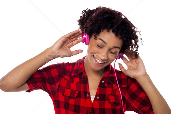 Casual woman lost in pleasant musical world Stock photo © stockyimages