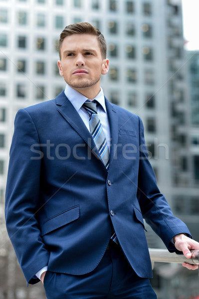 Handsome businessman posing outdoors Stock photo © stockyimages