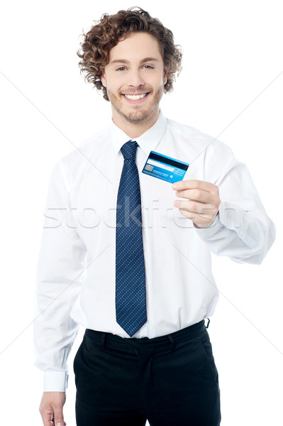 Happy man displaying his cash card Stock photo © stockyimages