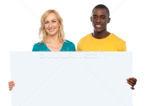 Attractive couple holding white blank ad board Stock photo © stockyimages