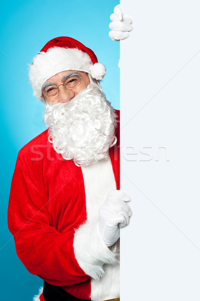 Santa posing beside long blank banner ad Stock photo © stockyimages