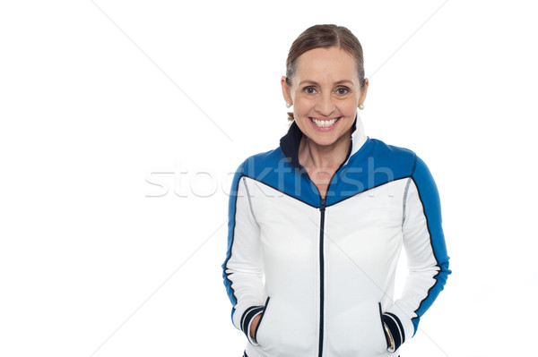 Woman in sporty jacket smiling warmly Stock photo © stockyimages