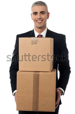 Smiling businessman holding carton box Stock photo © stockyimages