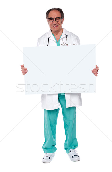 Confident doctor showing blank whiteboard Stock photo © stockyimages