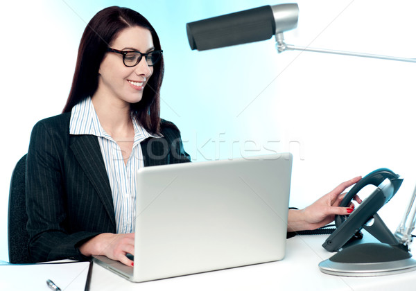 Female secretary answering phone call Stock photo © stockyimages