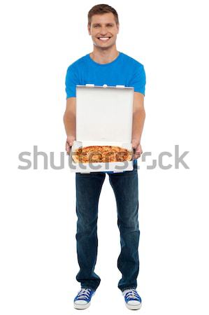 Casual guy showing freshly baked yummy pizza Stock photo © stockyimages