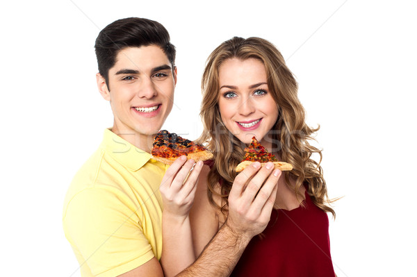 Couple enjoying pizza slices together Stock photo © stockyimages