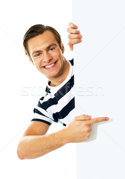 Handsome person pointing towards blank signboard Stock photo © stockyimages