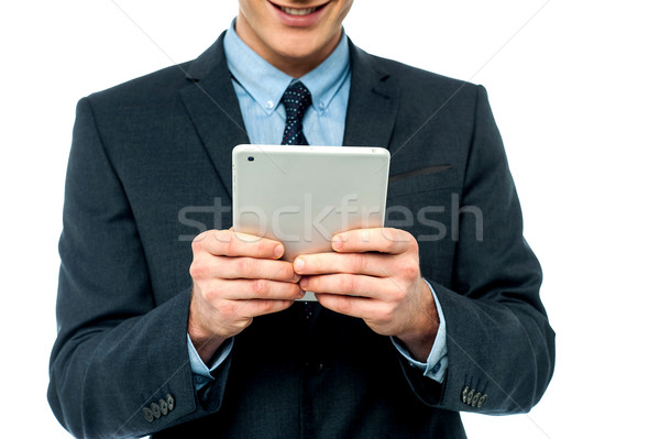 Businessman browsing on tablet pc Stock photo © stockyimages