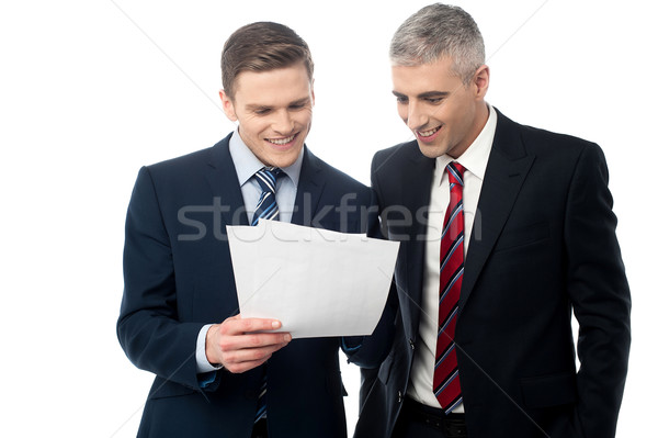 Confident businessmen reviewing records Stock photo © stockyimages